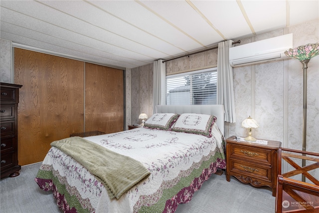 carpeted bedroom featuring a wall mounted AC