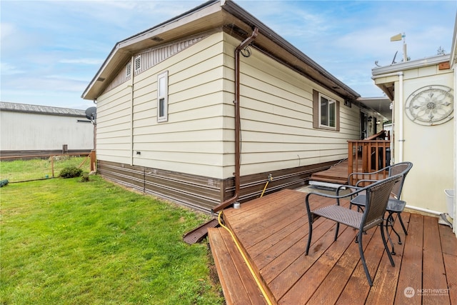 wooden deck featuring a yard