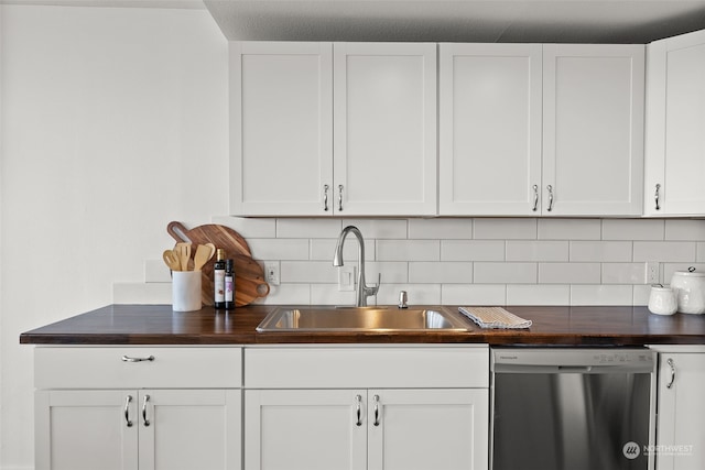 kitchen with dishwasher, a sink, backsplash, white cabinetry, and butcher block countertops