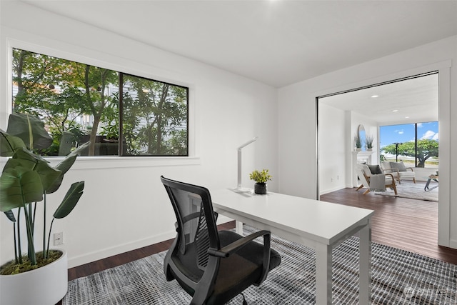 office area with dark wood-style floors and baseboards