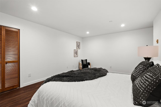 bedroom featuring baseboards, wood finished floors, and recessed lighting