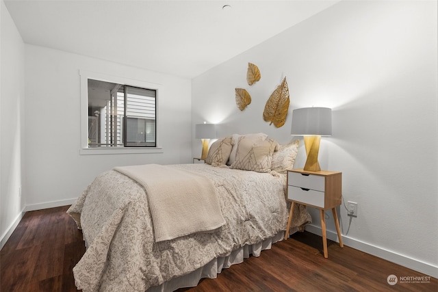 bedroom featuring baseboards and wood finished floors