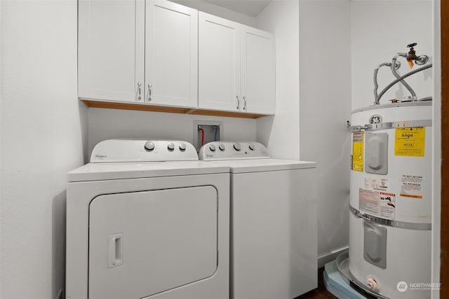 clothes washing area featuring secured water heater, cabinet space, and independent washer and dryer