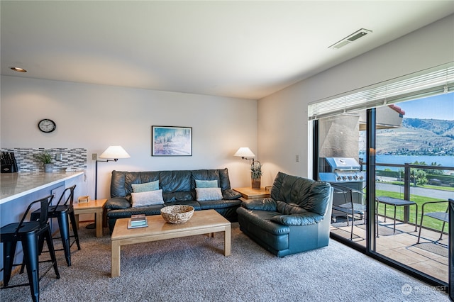 carpeted living room with a water view