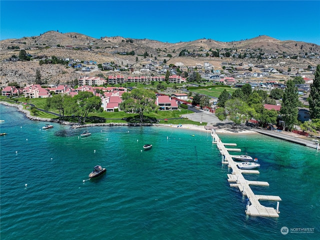 birds eye view of property with a water and mountain view