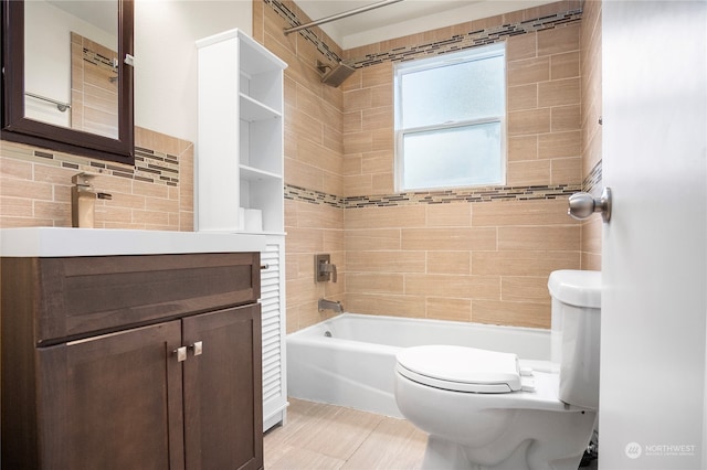 full bathroom with tiled shower / bath combo, vanity, and toilet