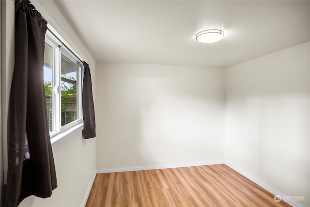 empty room with hardwood / wood-style flooring