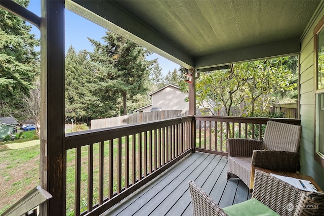 wooden deck featuring a lawn