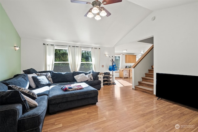 living room featuring high vaulted ceiling, light wood-type flooring, and ceiling fan