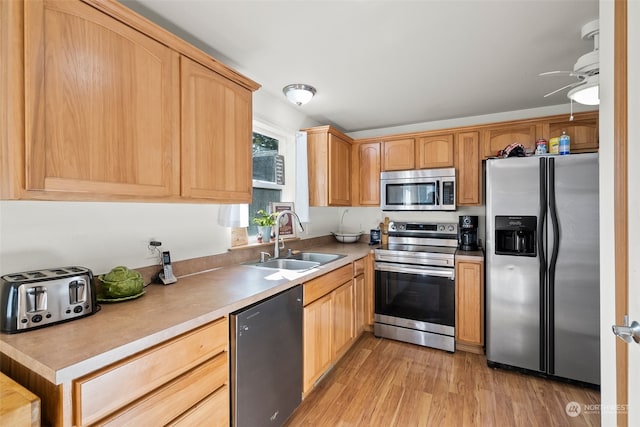 kitchen featuring light hardwood / wood-style flooring, appliances with stainless steel finishes, sink, and light brown cabinetry