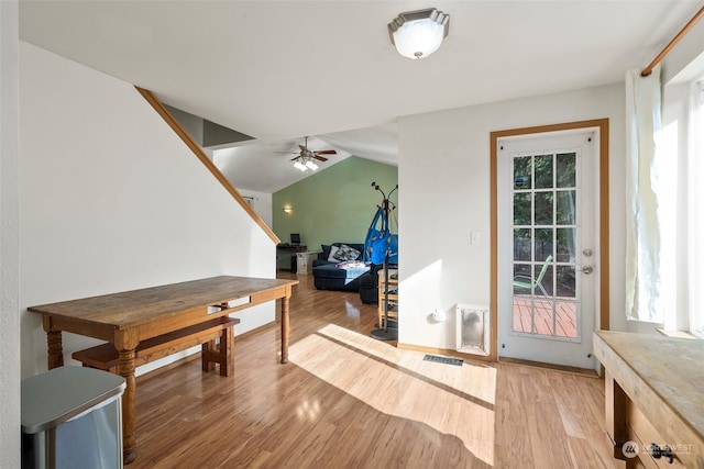 interior space featuring light wood-type flooring, ceiling fan, and vaulted ceiling