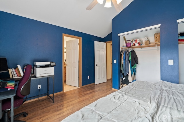 bedroom with wood-type flooring, a closet, lofted ceiling, and ceiling fan