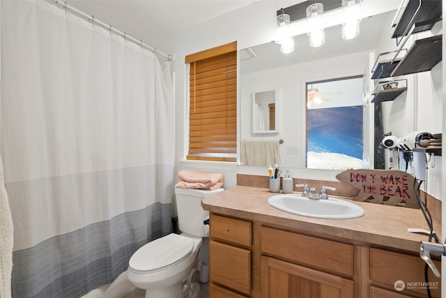 bathroom featuring ceiling fan, vanity, toilet, and a shower with shower curtain