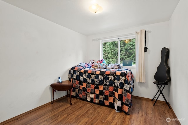 bedroom with hardwood / wood-style flooring