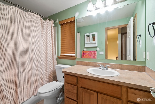 bathroom with vanity, toilet, and a shower with shower curtain