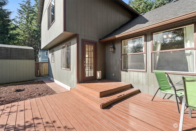 wooden deck with a storage shed