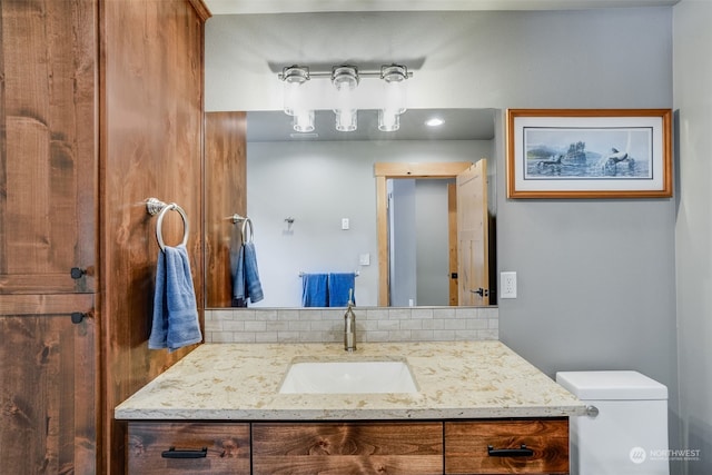 bathroom featuring toilet and vanity