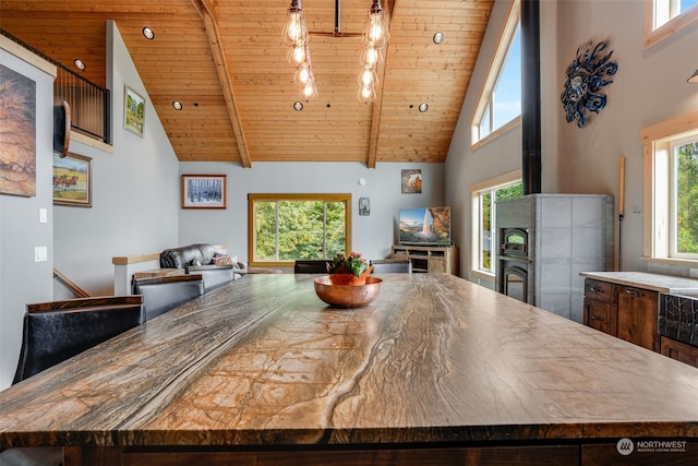 dining area with high vaulted ceiling, beamed ceiling, and wooden ceiling