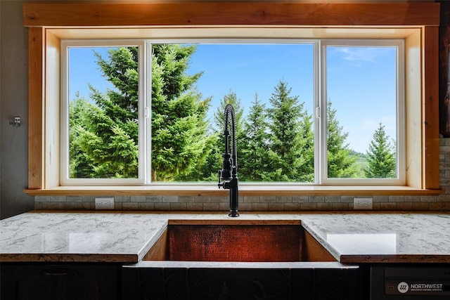 details with light stone countertops and sink