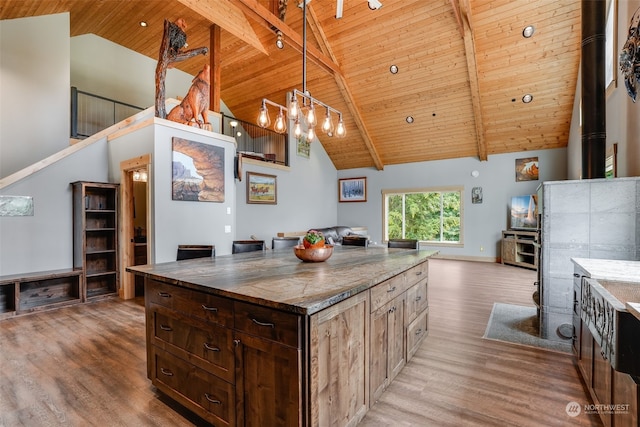 kitchen with high vaulted ceiling, wood ceiling, and light hardwood / wood-style floors