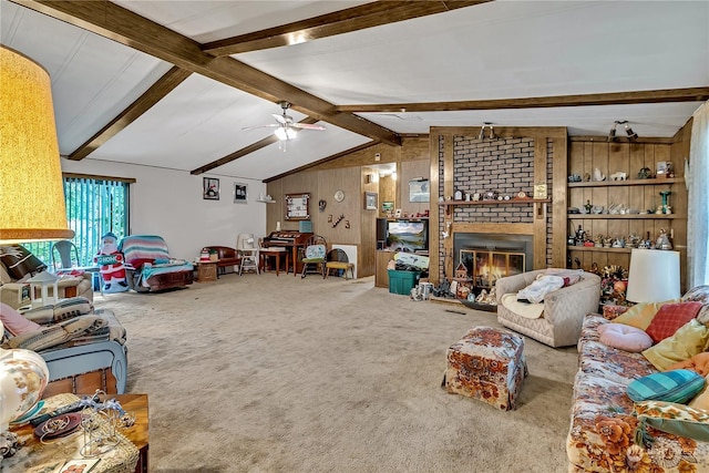 carpeted living area featuring a ceiling fan, wood walls, vaulted ceiling with beams, and a fireplace