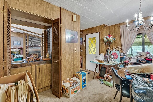 carpeted dining space featuring an inviting chandelier and wood walls
