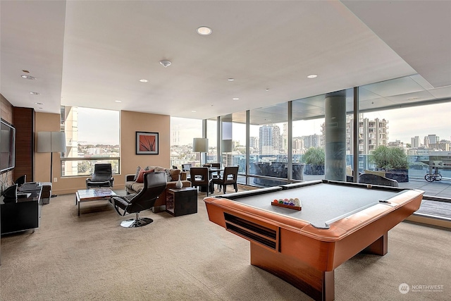 rec room with a healthy amount of sunlight, light carpet, and billiards