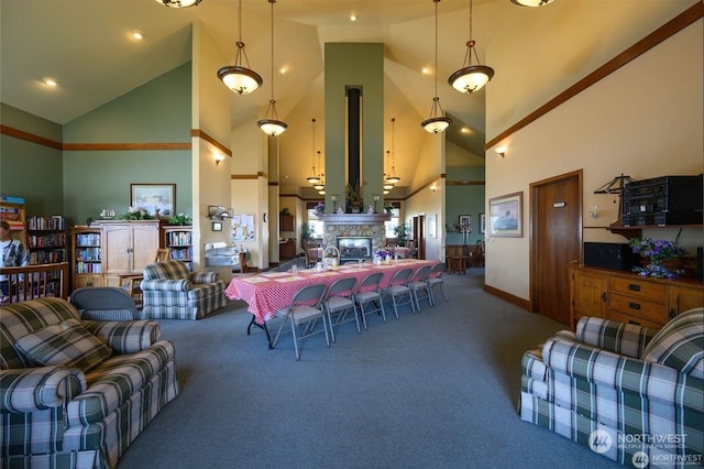 living room featuring carpet, high vaulted ceiling, and a fireplace