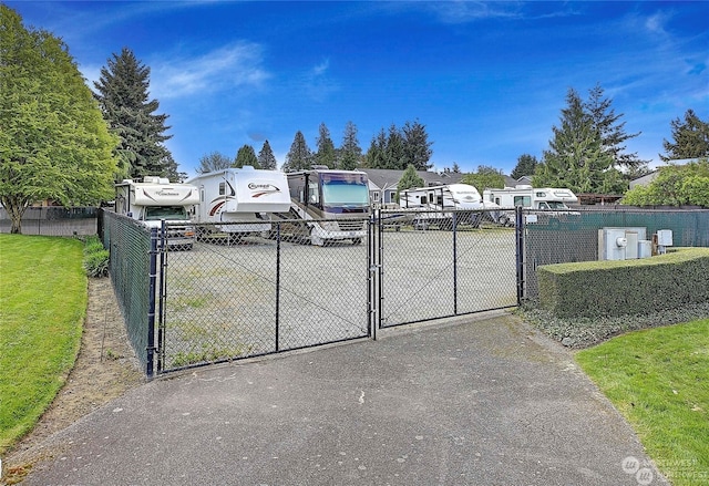 view of gate with a yard