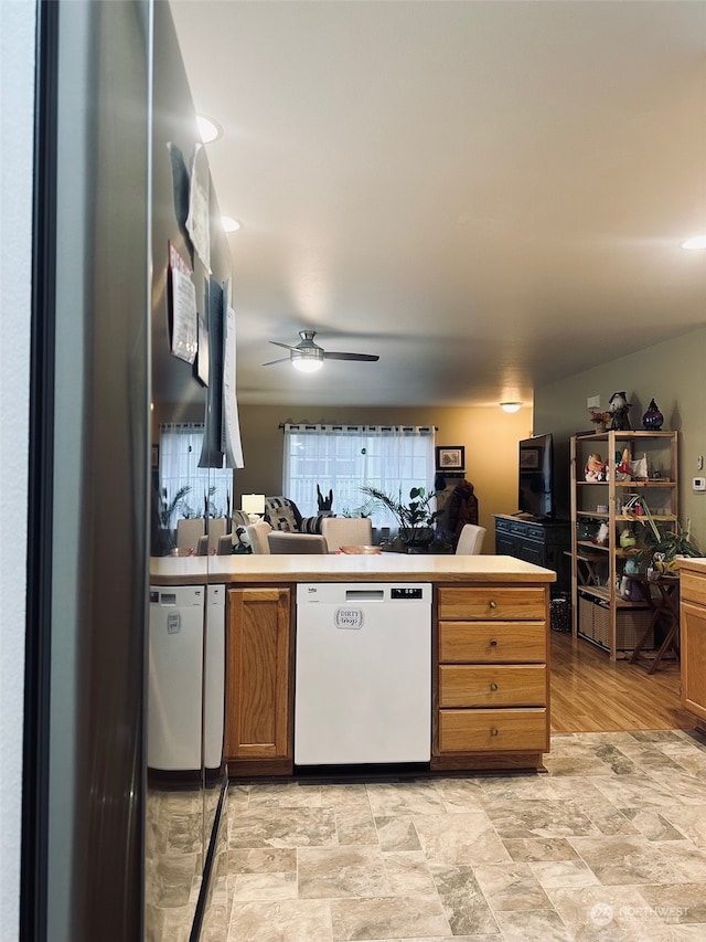 kitchen featuring dishwasher, ceiling fan, kitchen peninsula, and light hardwood / wood-style flooring