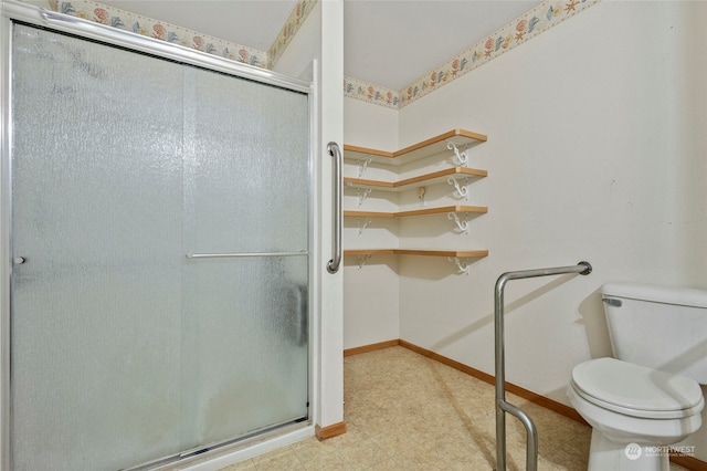 bathroom featuring toilet and an enclosed shower