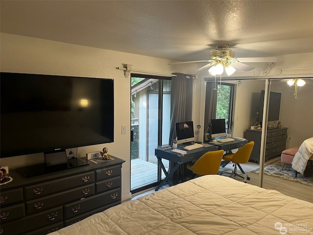 bedroom featuring ceiling fan, a textured ceiling, light hardwood / wood-style floors, and access to exterior