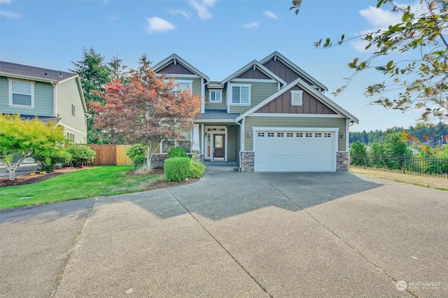 craftsman inspired home with a garage and a front lawn