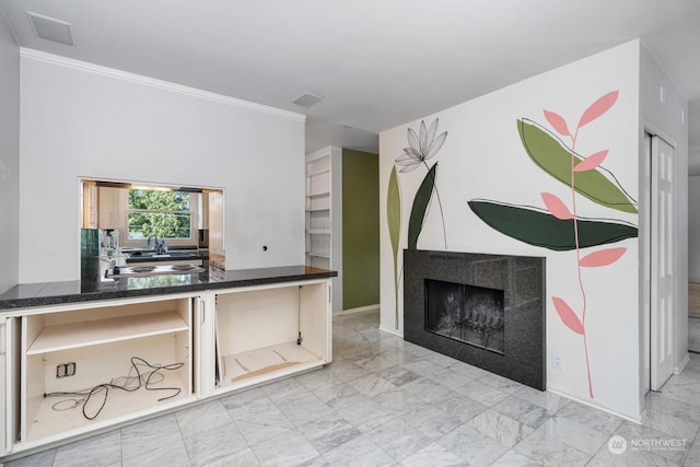 living room featuring ornamental molding and a tiled fireplace