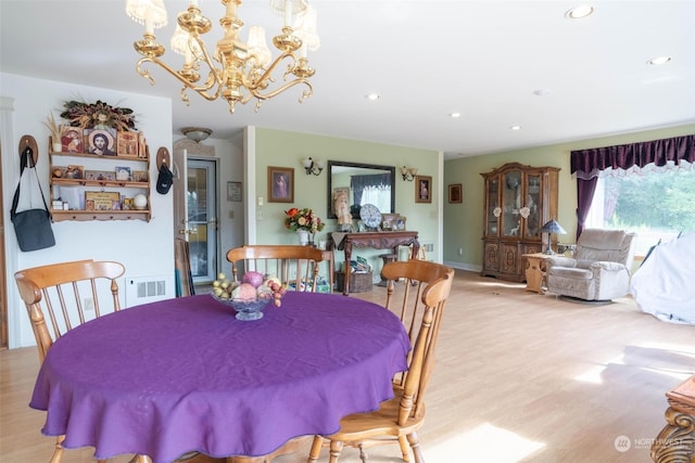 dining room featuring light hardwood / wood-style floors and a notable chandelier