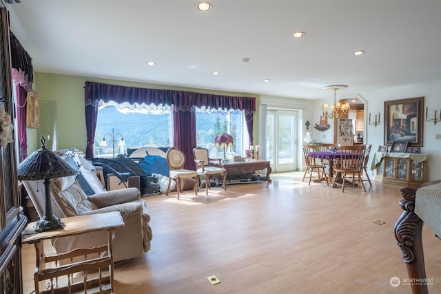 living room featuring an inviting chandelier and light hardwood / wood-style flooring