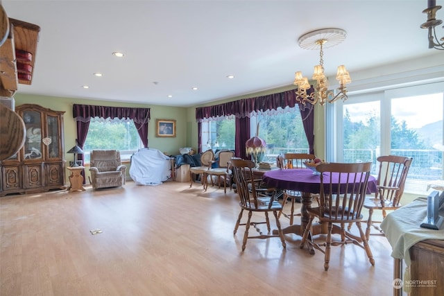 dining area featuring a chandelier and light hardwood / wood-style floors