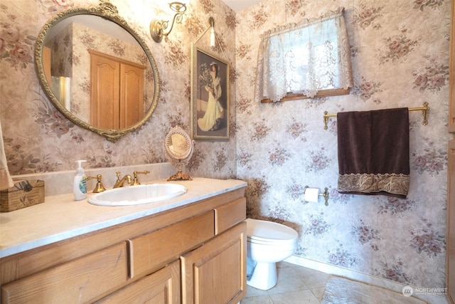 bathroom featuring vanity, tile patterned flooring, and toilet