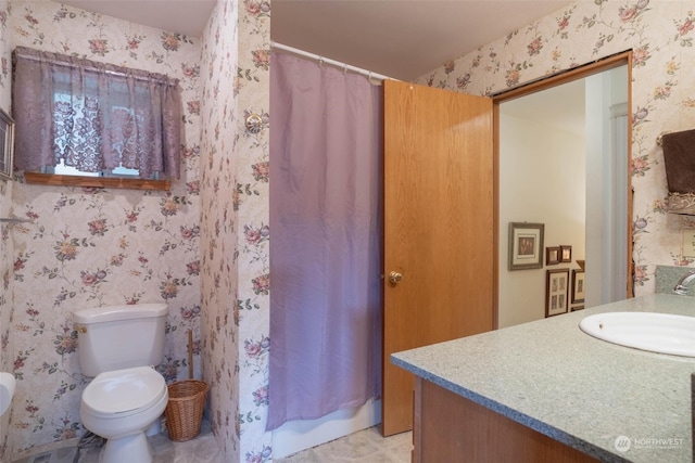 bathroom featuring tile patterned floors, vanity, toilet, and curtained shower