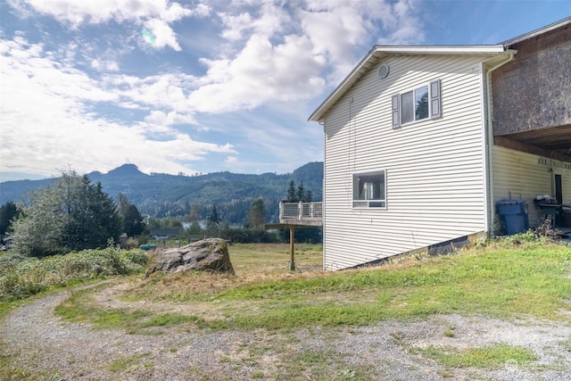 view of side of home with a mountain view