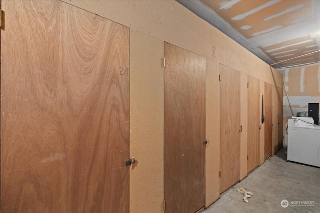 interior space featuring concrete floors, washer / clothes dryer, and electric panel