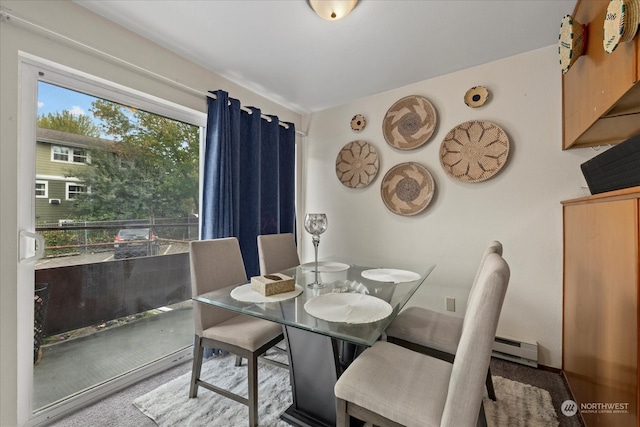 dining area featuring light colored carpet and a baseboard radiator