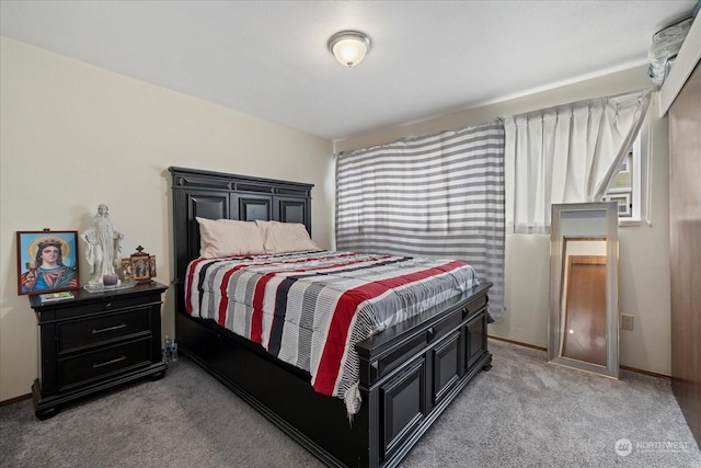 carpeted bedroom featuring baseboards