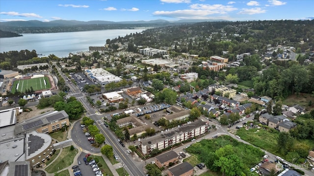 birds eye view of property with a water and mountain view