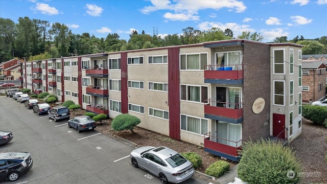 view of building exterior with uncovered parking