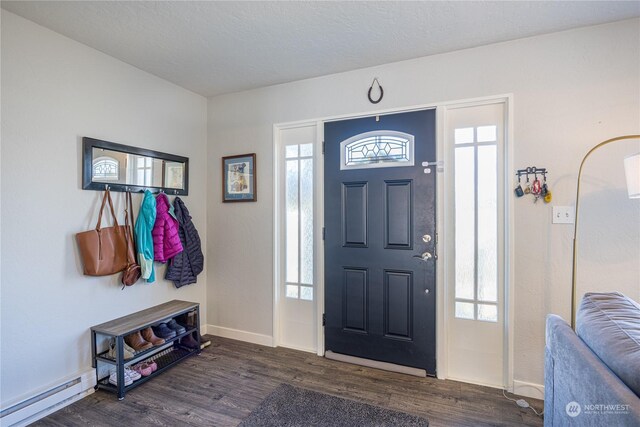 entrance foyer with a baseboard heating unit, a textured ceiling, dark hardwood / wood-style floors, and a healthy amount of sunlight