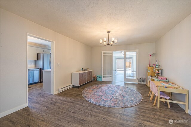 interior space with a notable chandelier, a textured ceiling, a baseboard radiator, and dark wood-type flooring