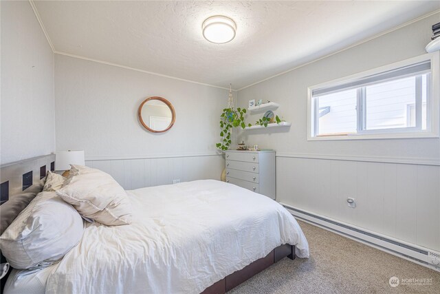 bedroom with baseboard heating and carpet floors