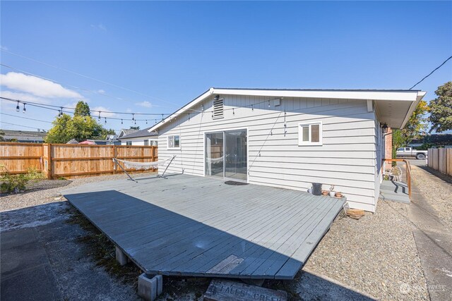 rear view of house featuring a wooden deck