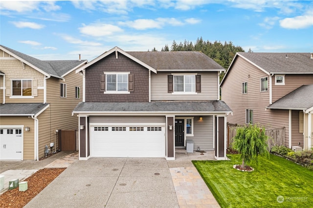 view of front of property with a garage and a front lawn